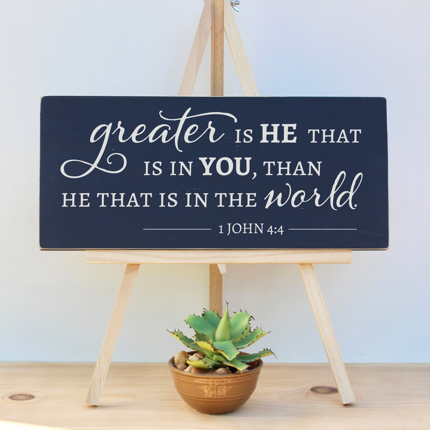 Greater is He that is in you, than he that is in the world. 1 John 4:4 Encouraging scripture sign in navy blue chalk paint.