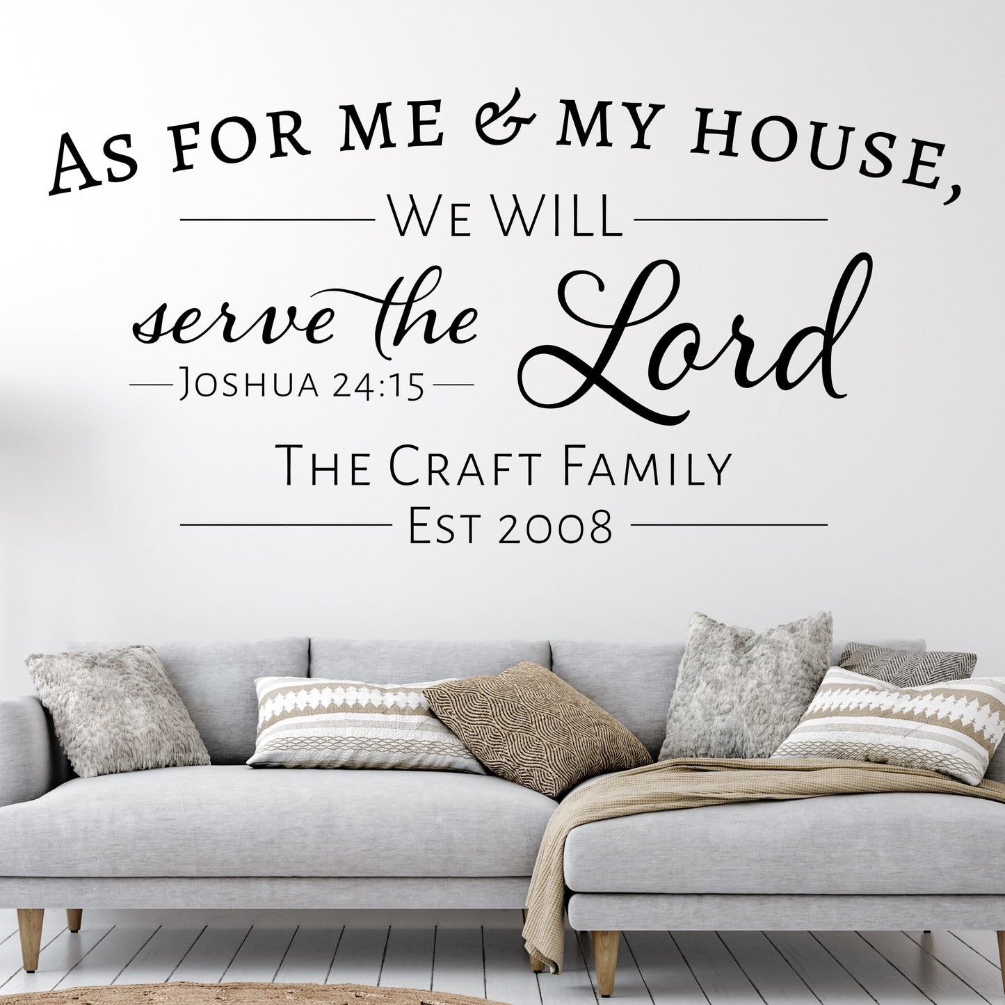 This removable wall decal for a lving room features the text, "As for me and my house, we will serve the Lord. Joshua 24:15. Underneath the Bible verse are a personalized family name and an established date.