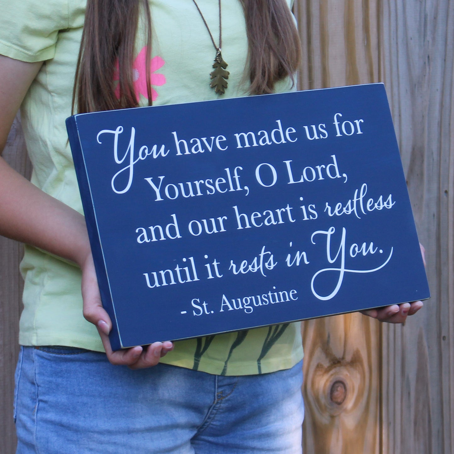 This rustic wooden sign features the following St Augustine quote, You have made us for yourself, o Lord,and our heart is restless until it rests in you. St Augustine. This sign is navy blue with white text.