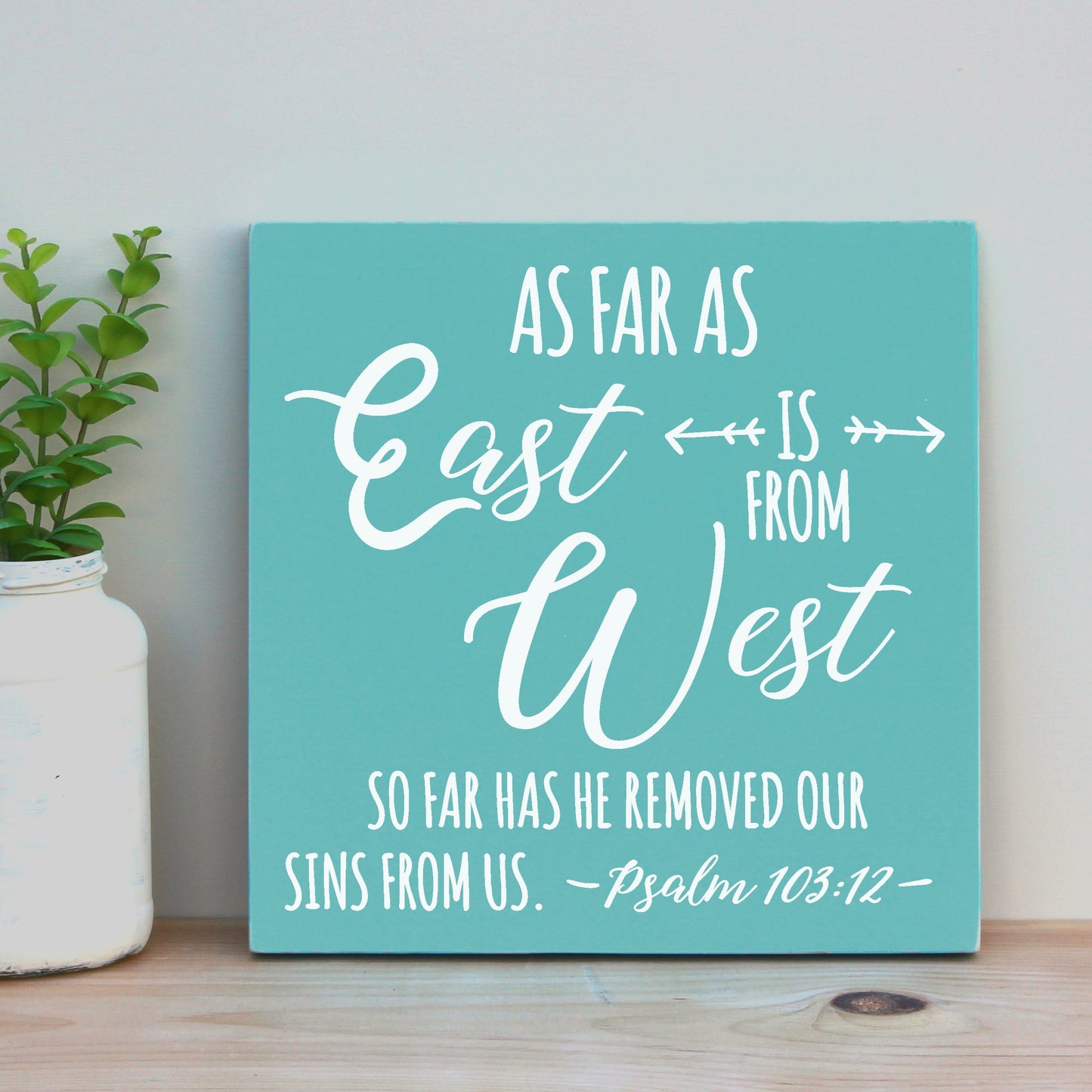 As far as the east is from the west, so far has he removed our sins from us.  Psalm 103:12.  12 X 12 inch handmade, wooden scripture sign.