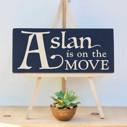 Rustic wooden sign featuring the text, Aslan is on the MOVE.  The perfect Narnia wall art for any Narnia themed nursery, bedroom, book nook or library.