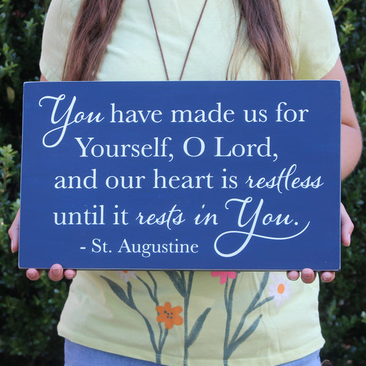 Beautiful piece of St Augustine wall art.  This St Augustine quote reads, You have made us for yourself, o Lord, and our heart is restless until it rests in you.  St Augustine.  This rustic Christian sign has a navy blue background and white text.