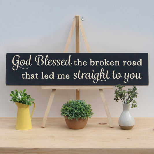 Wooden Quote sign that reads, "God blessed the broken road that led me straight to you."